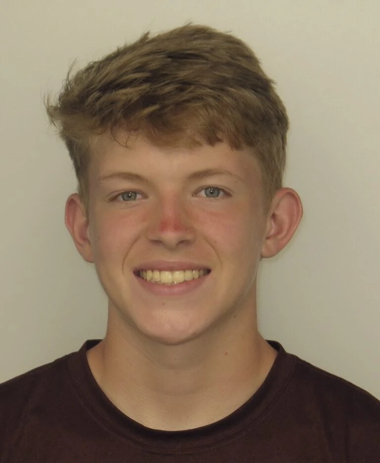 Smiling young male patient showcasing orthodontic treatment results, highlighting improved dental aesthetics and confidence.